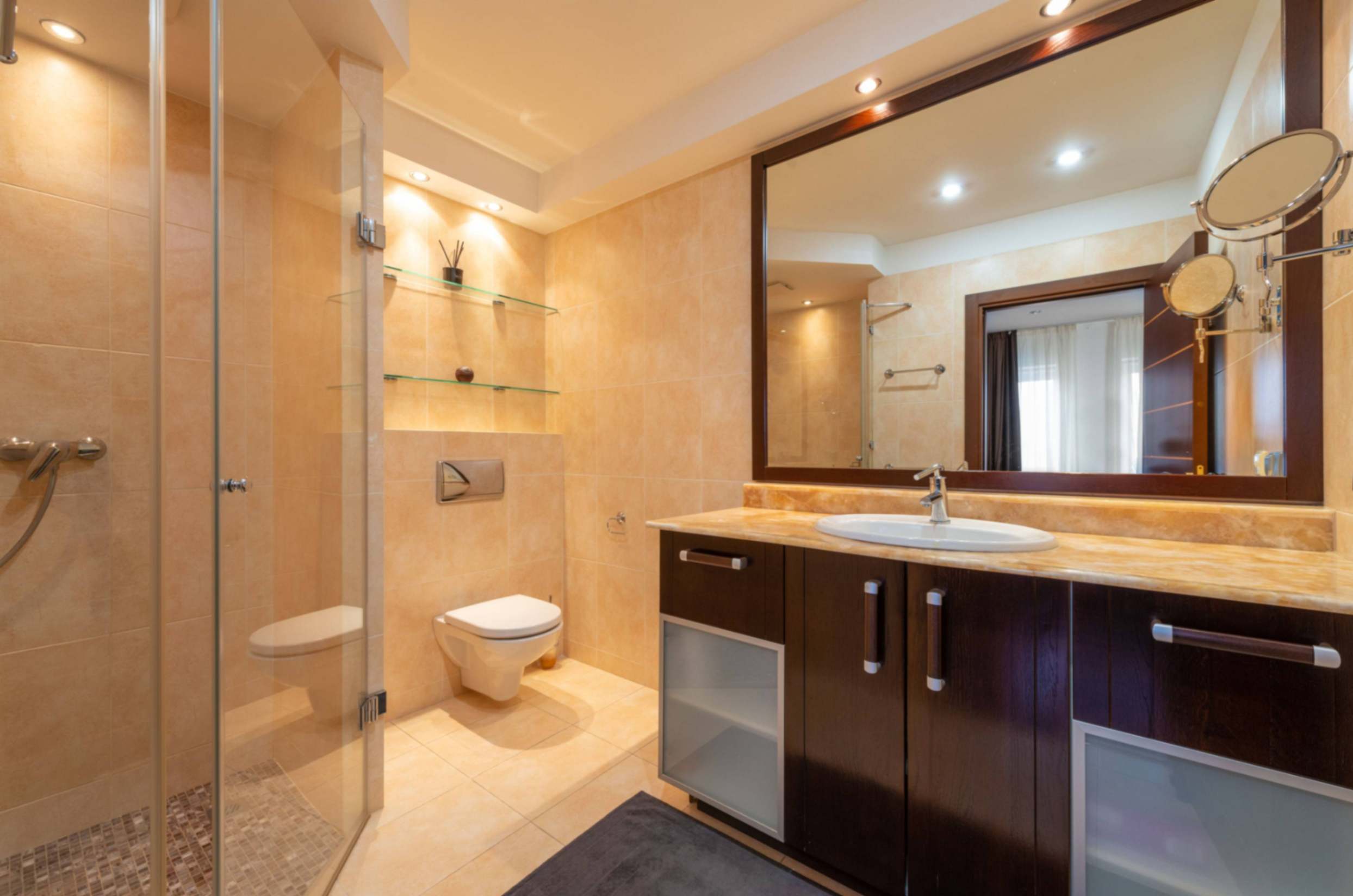 : Large bathroom mirror reflecting light and space